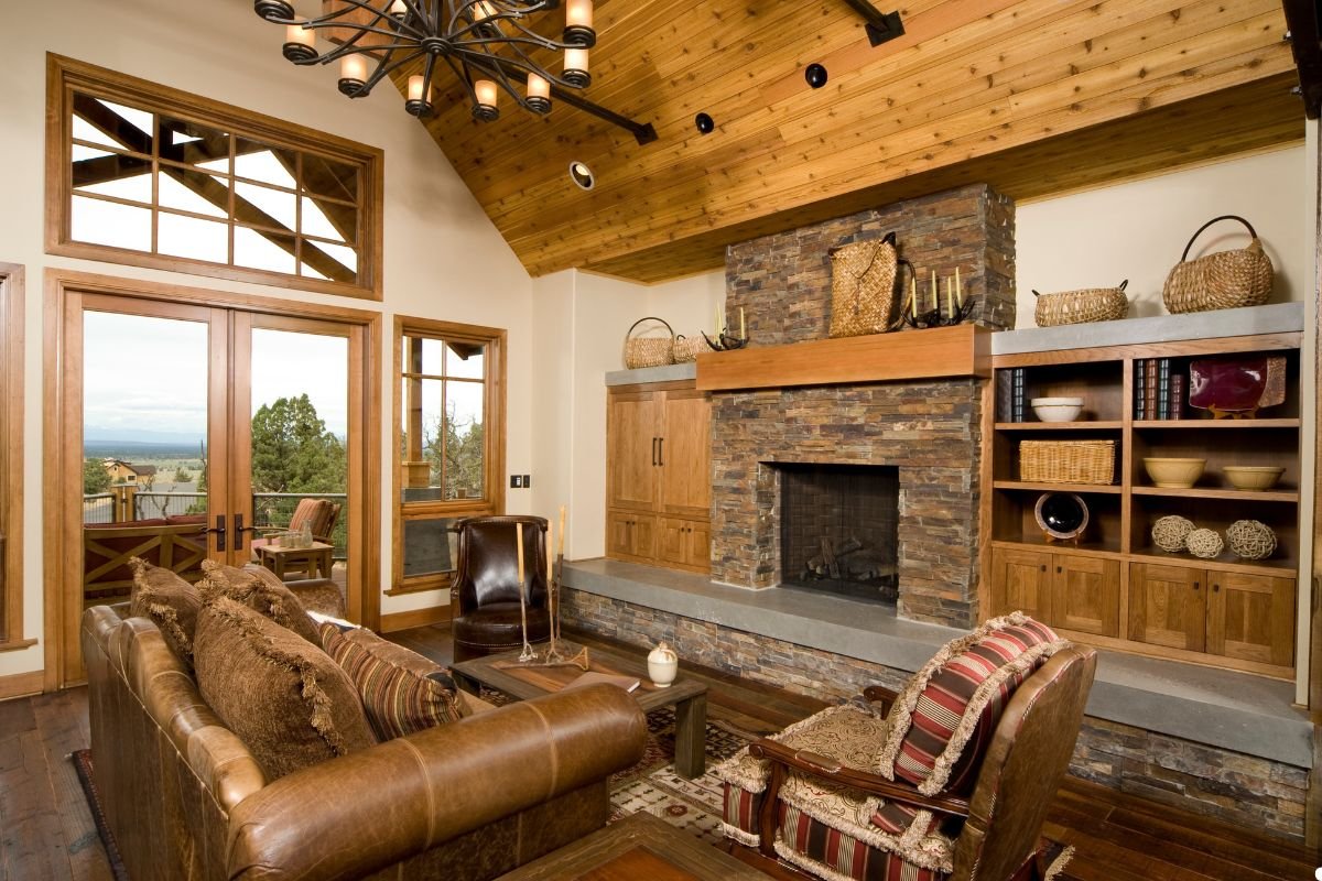 A cozy living room featuring a stone fireplace and warm wood floors, creating an inviting atmosphere.